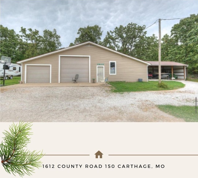 exterior space with a carport, a garage, and an outdoor structure