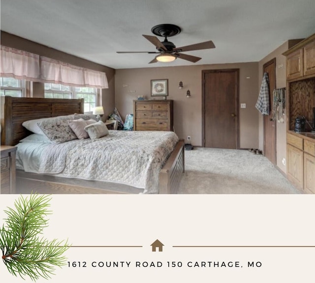 bedroom featuring light carpet and ceiling fan