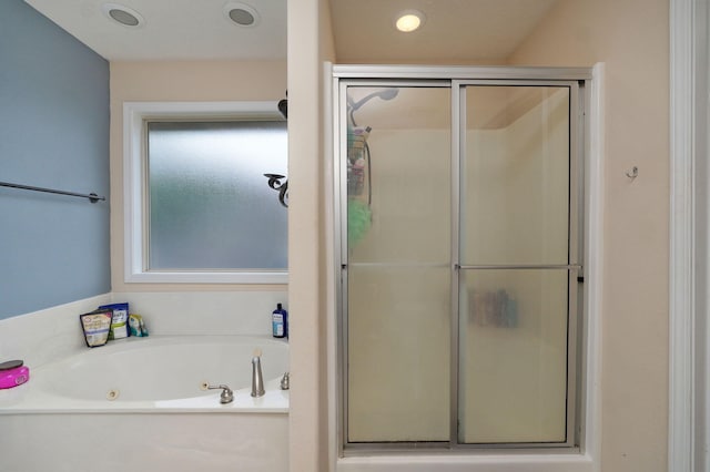 bathroom with shower with separate bathtub