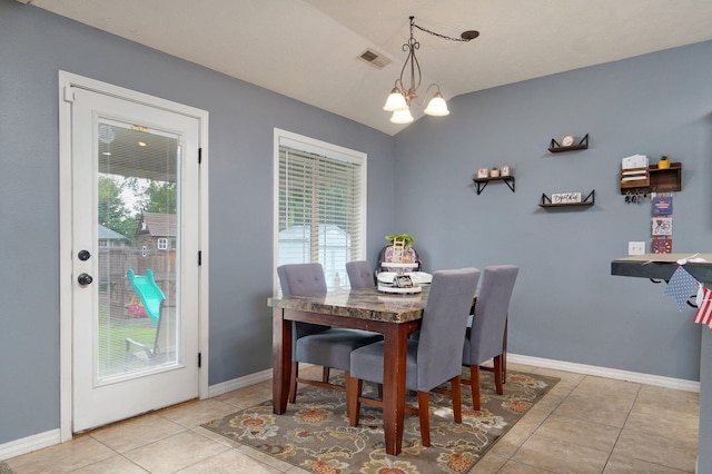 dining room featuring a notable chandelier, light tile patterned floors, and a wealth of natural light