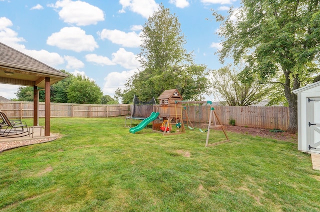 view of yard featuring a trampoline and a playground