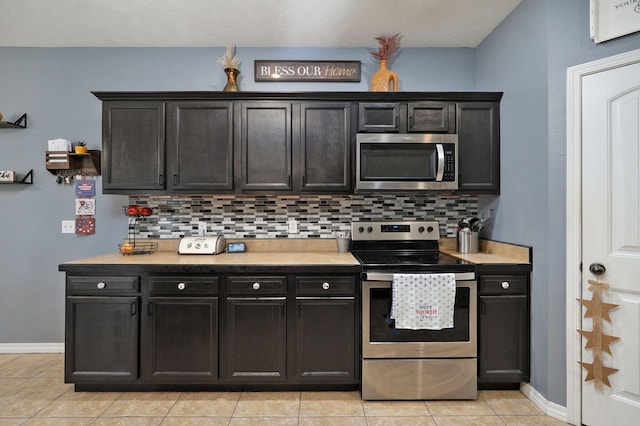 kitchen featuring appliances with stainless steel finishes, backsplash, and light tile patterned floors