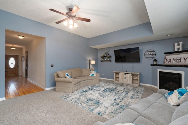 living room with ceiling fan and light wood-type flooring