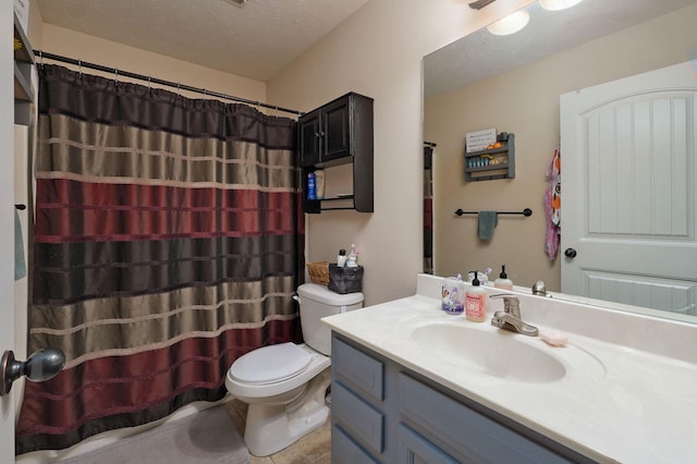 bathroom with vanity, a textured ceiling, and toilet