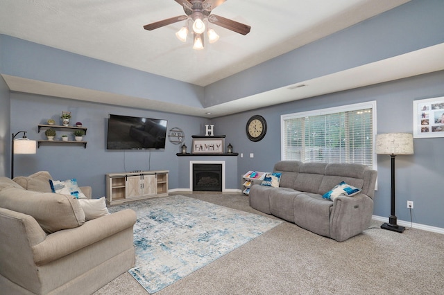 carpeted living room featuring ceiling fan