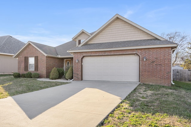 view of front of property featuring a garage and a front lawn