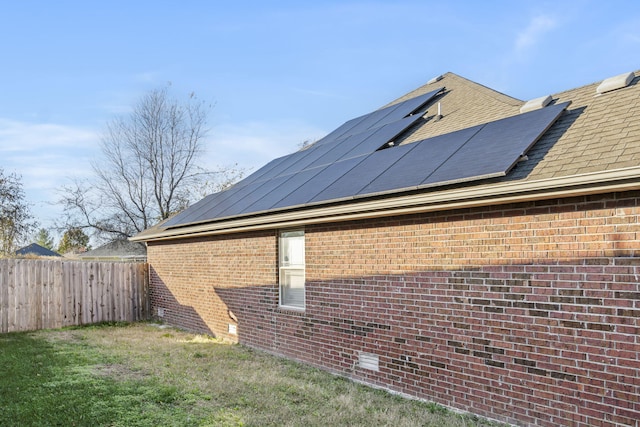 view of side of property with solar panels