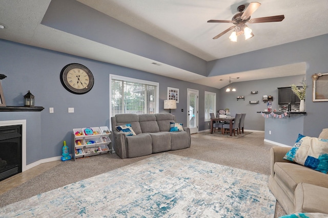 carpeted living room with ceiling fan