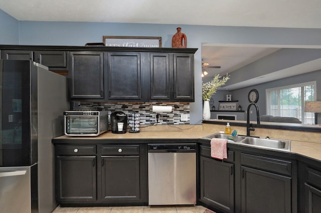 kitchen featuring sink, ceiling fan, light tile patterned floors, appliances with stainless steel finishes, and tasteful backsplash