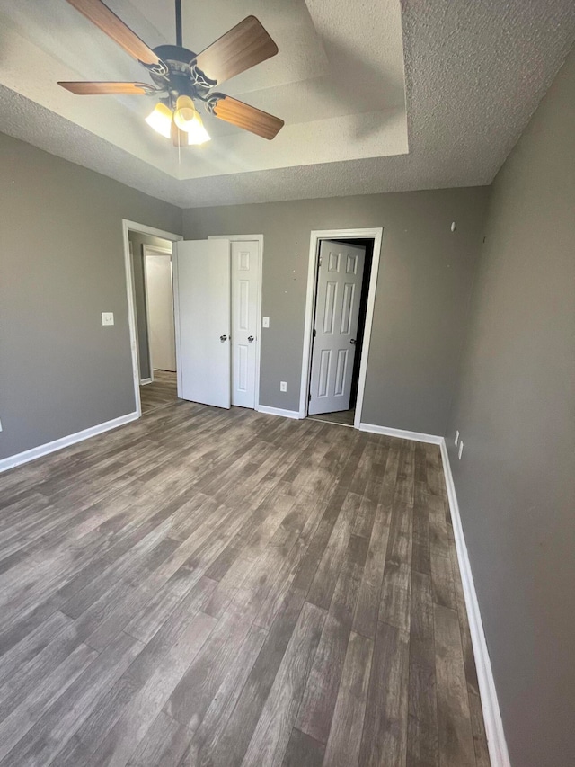 unfurnished bedroom with wood-type flooring, a textured ceiling, and ceiling fan