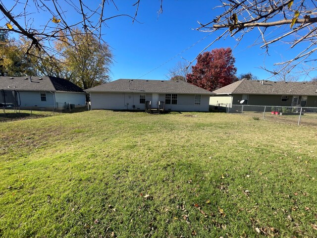 rear view of house with a lawn