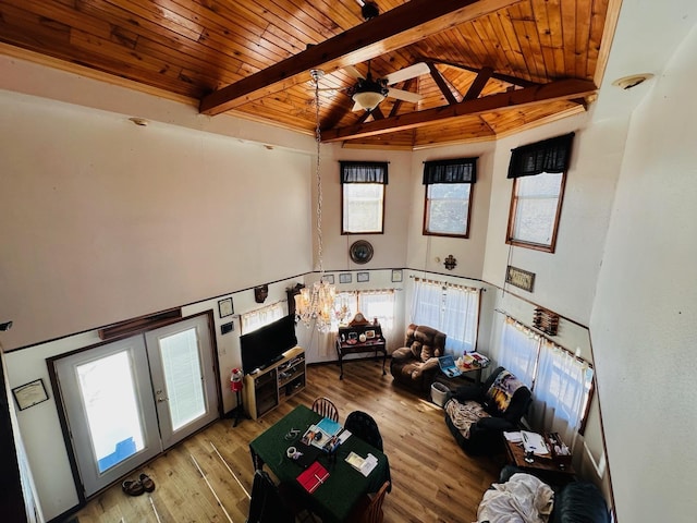 living room featuring light wood-type flooring, wood ceiling, ceiling fan, beam ceiling, and high vaulted ceiling