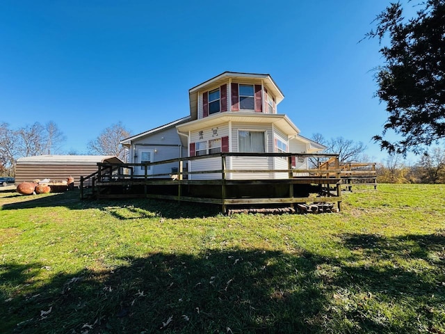 back of property with a yard and a wooden deck