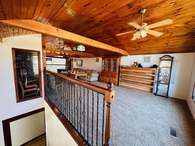 interior space featuring vaulted ceiling with beams and wooden ceiling