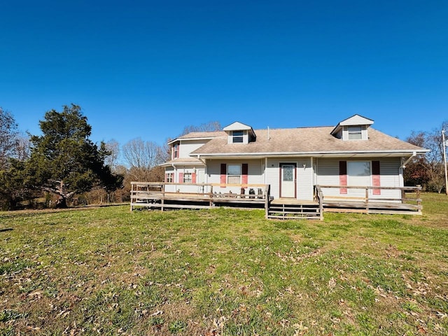 back of property with a lawn and a wooden deck