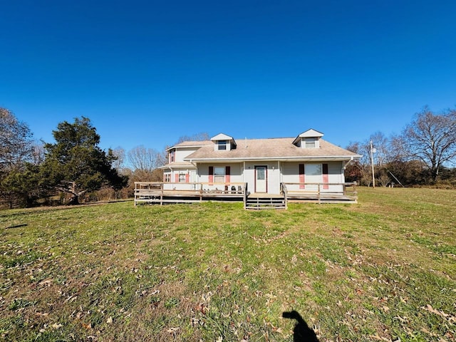 rear view of house featuring a yard and a wooden deck