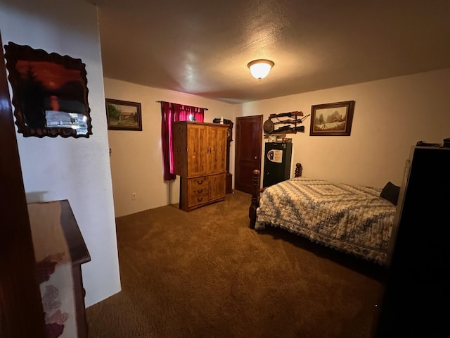 bedroom with carpet floors and a textured ceiling