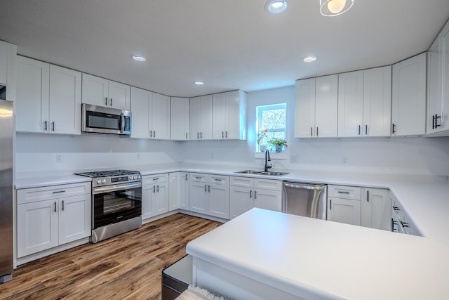 kitchen featuring white cabinets, sink, and appliances with stainless steel finishes