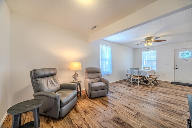 living area featuring ceiling fan and light hardwood / wood-style floors