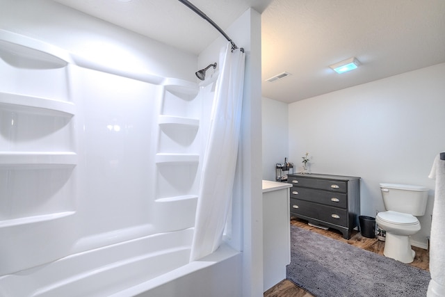 full bathroom with wood-type flooring, vanity, toilet, and shower / bath combination with curtain