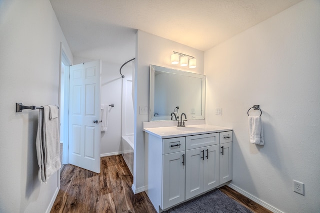 bathroom featuring shower / bath combination, vanity, and wood-type flooring