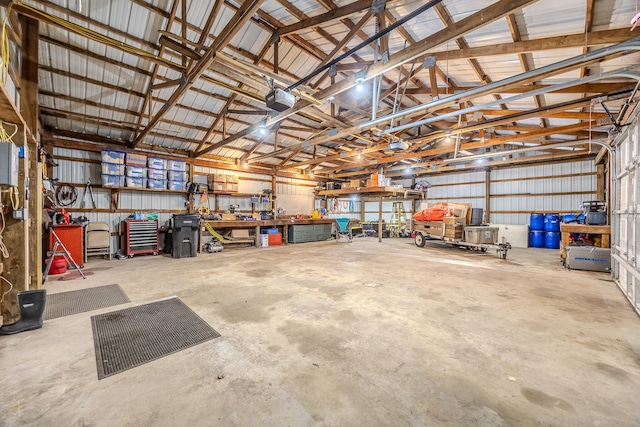 garage with a workshop area and a garage door opener