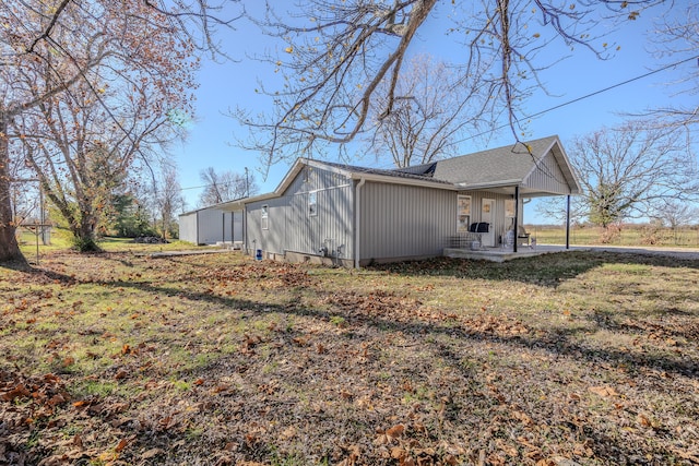 view of side of home featuring a lawn