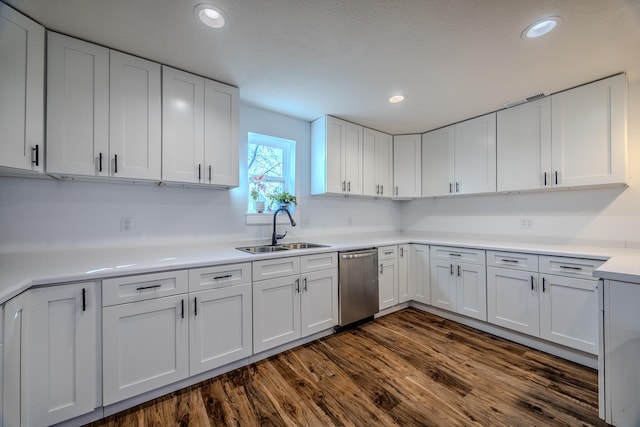 kitchen featuring dishwasher, white cabinetry, sink, and dark wood-type flooring