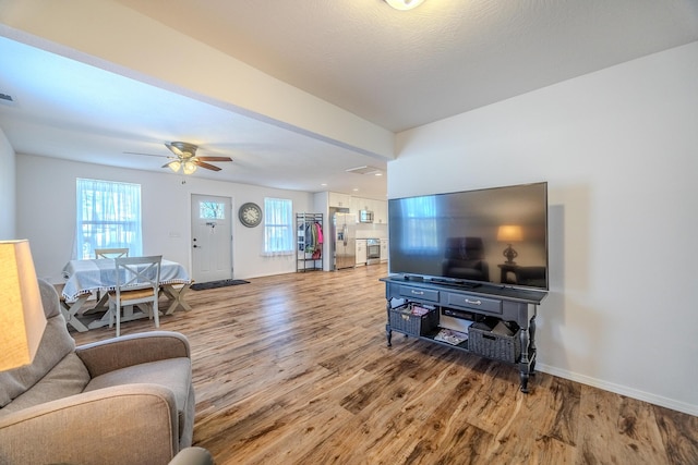 538 W Mack Rd, Seymour, MO 65746 - living room featuring light wood-style floors, baseboards, and a ceiling fan