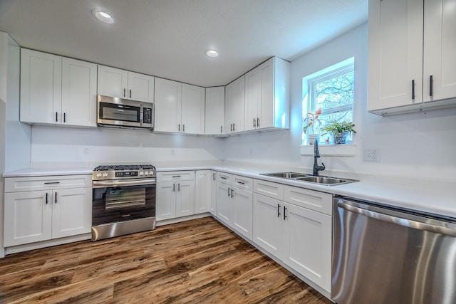 538 W Mack Rd, Seymour, MO 65746 - kitchen with appliances with stainless steel finishes, a sink, white cabinetry, light countertops, and dark wood-type flooring