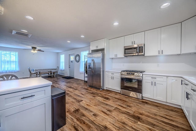 538 W Mack Rd, Seymour, MO 65746 - kitchen with appliances with stainless steel finishes, dark wood-style flooring, white cabinets, recessed lighting, and a ceiling fan