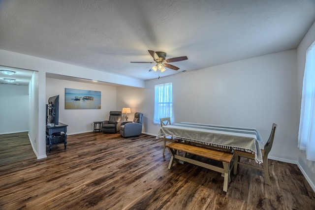 interior space with ceiling fan, dark hardwood / wood-style flooring, and a textured ceiling