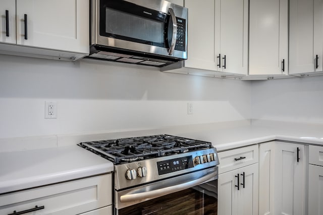 kitchen featuring white cabinets and appliances with stainless steel finishes