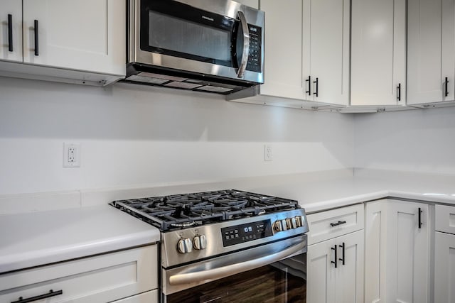538 W Mack Rd, Seymour, MO 65746 - kitchen with appliances with stainless steel finishes, light countertops, and white cabinetry