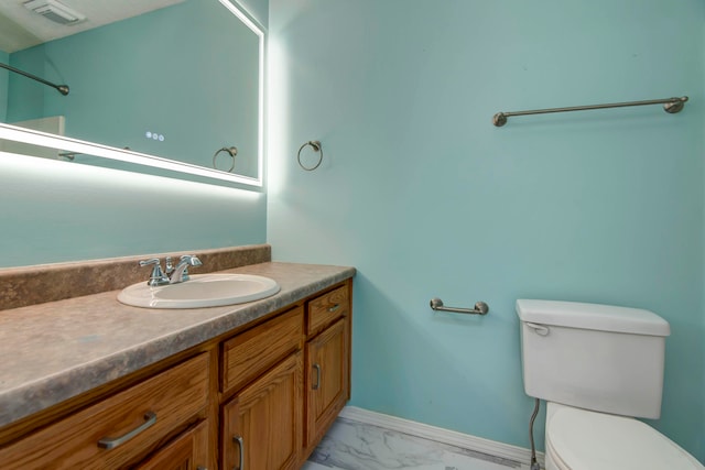 bathroom featuring vanity and toilet