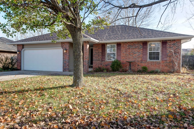 ranch-style home featuring a garage and a front lawn