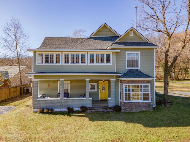 view of front of property with a porch and a front yard