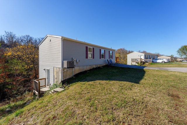 view of home's exterior with a yard and cooling unit