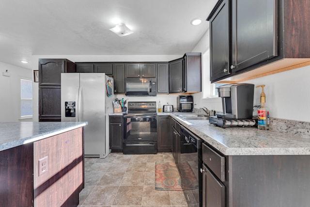 kitchen featuring black appliances, dark brown cabinetry, and sink