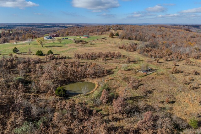 birds eye view of property with a rural view and a water view