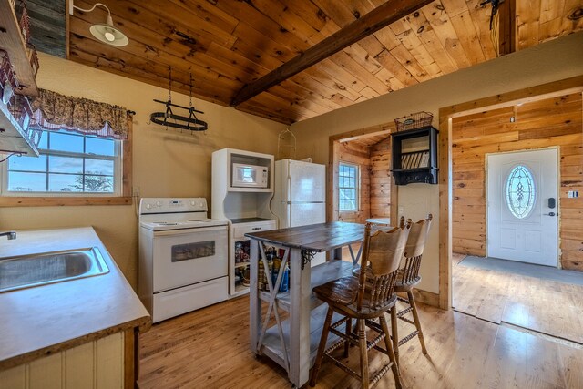 kitchen with sink, a healthy amount of sunlight, white appliances, and light hardwood / wood-style floors