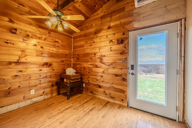 doorway featuring ceiling fan, lofted ceiling with beams, light hardwood / wood-style floors, wooden walls, and wood ceiling