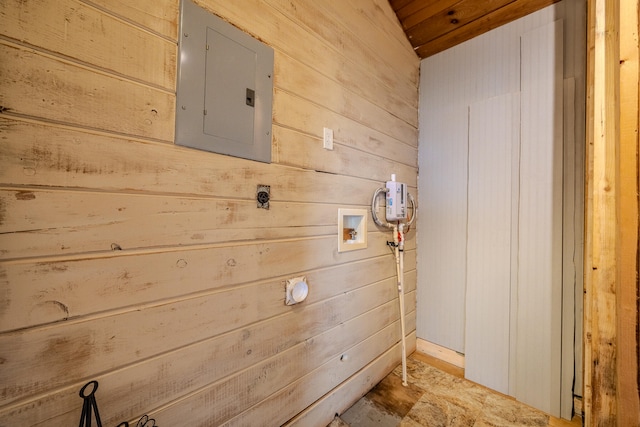 room details featuring electric panel and wooden walls