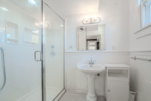 bathroom with a textured ceiling and walk in shower