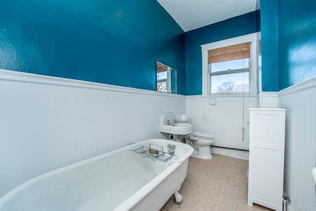 bathroom with toilet and a tub