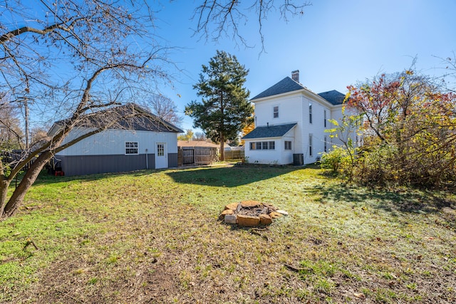 view of yard featuring an outdoor fire pit and cooling unit