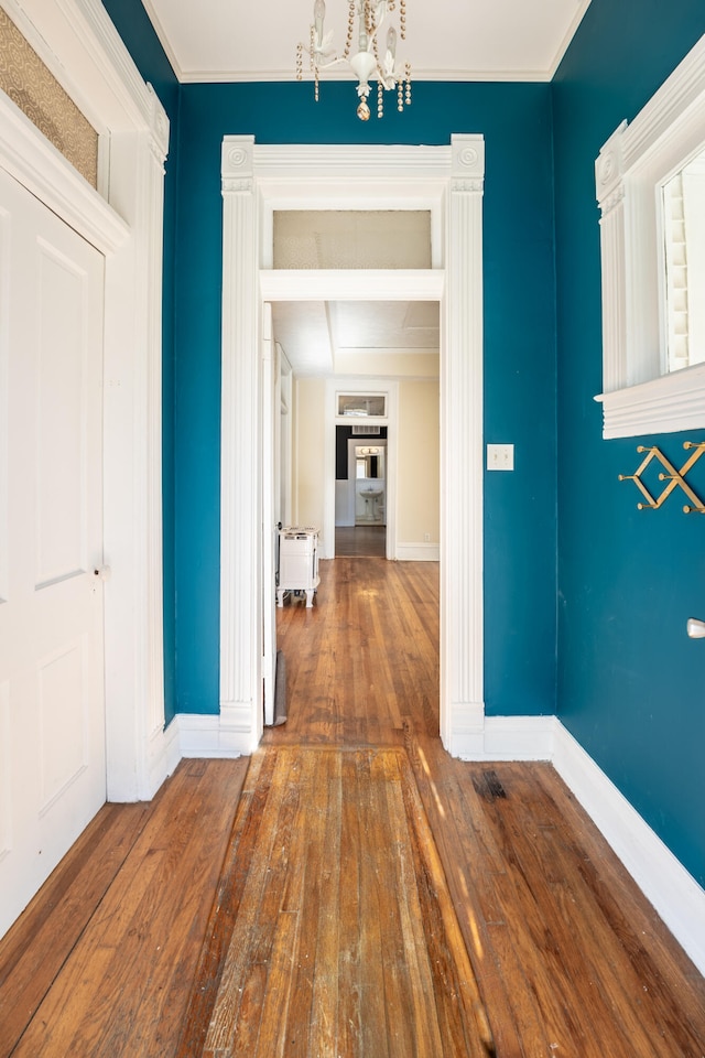 hall featuring a chandelier and dark hardwood / wood-style floors