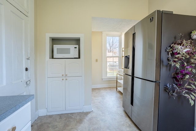 kitchen with stainless steel fridge with ice dispenser