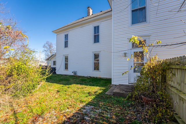 back of property featuring a lawn