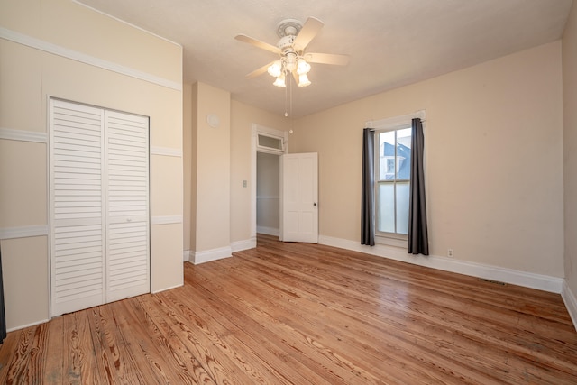 unfurnished bedroom featuring a closet, ceiling fan, and light hardwood / wood-style flooring